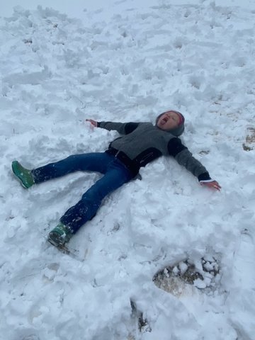 Emma Jackson, 6, tries to make a snow angel.